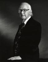 Two B&W photographs of Professor Peter Higgs.