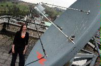 A set of photographs of Keri Niccoll, likely a student of the University of Edinburgh Meteorology department.  Pictures are included on top of the JCMB roof and with a projection of a weather map on her face.  Likely taken for the Science and Engineering magazine.