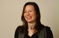 A set of photographs of Keri Niccoll, likely a student of the University of Edinburgh Meteorology department.  Pictures are included on top of the JCMB roof and with a projection of a weather map on her face.  Likely taken for the Science and Engineering magazine.
