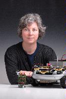 A set of photographs of Professor Barbara Webb of the University of Edinburgh School of Informatics.  Pictured with electronic circuitry and components.