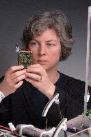 A set of photographs of Professor Barbara Webb of the University of Edinburgh School of Informatics.  Pictured with electronic circuitry and components.