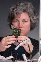 A set of photographs of Professor Barbara Webb of the University of Edinburgh School of Informatics.  Pictured with electronic circuitry and components.