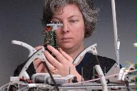 A set of photographs of Professor Barbara Webb of the University of Edinburgh School of Informatics.  Pictured with electronic circuitry and components.