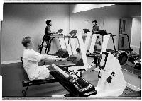 A set of images of people working out at a gym.  Taken February 2003.
