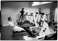 A set of images of people working out at a gym.  Taken February 2003.
