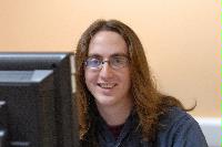 A set of photographs of a man named James Addison, pictured with computers.  Images taken for the Science and Engineering publication in March 2007.