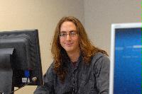 A set of photographs of a man named James Addison, pictured with computers.  Images taken for the Science and Engineering publication in March 2007.