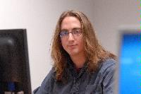 A set of photographs of a man named James Addison, pictured with computers.  Images taken for the Science and Engineering publication in March 2007.