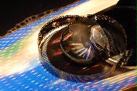 Photographs of a roll of video film and a film tin.