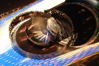 Photographs of a roll of video film and a film tin.