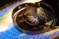 Photographs of a roll of video film and a film tin.