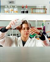 A set of images of unknown students performing chemistry experiments.