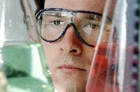 A set of images of unknown students performing chemistry experiments.