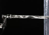 A series of photographs of glass flutes for an acoustics experiment to show the response of the air in the flute to incoming air when it is played, as well as the extablishment of a standing wave. It is shown by using pollen and photographing the pattern of the pollen. Photographed by Peter Tuffy.