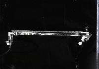 A series of photographs of glass flutes for an acoustics experiment to show the response of the air in the flute to incoming air when it is played, as well as the extablishment of a standing wave. It is shown by using pollen and photographing the pattern of the pollen. Photographed by Peter Tuffy.
