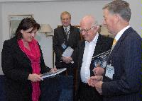 Photographs of Professor Peter Higgs and Professor Richard Kenway visiting St Andrews House, on Regent Road, Calton Hill, Edinburgh. In one of the photographs Professor Higgs can be seen signing a copy of "Exploring the Mystery of Matter", a hardcover book about the ATLAS Experiment. Photographs taken on the 10th of September, 2008.