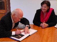 Photographs of Professor Peter Higgs and Professor Richard Kenway visiting St Andrews House, on Regent Road, Calton Hill, Edinburgh. In one of the photographs Professor Higgs can be seen signing a copy of "Exploring the Mystery of Matter", a hardcover book about the ATLAS Experiment. Photographs taken on the 10th of September, 2008.