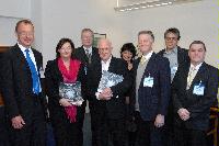 Photographs of Professor Peter Higgs and Professor Richard Kenway visiting St Andrews House, on Regent Road, Calton Hill, Edinburgh. In one of the photographs Professor Higgs can be seen signing a copy of "Exploring the Mystery of Matter", a hardcover book about the ATLAS Experiment. Photographs taken on the 10th of September, 2008.