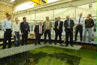 Photographs of Electricite de France (EDF) staff visiting a laboratory with a wave tank in the University of University.