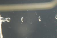 Photographs of a physics experiment entitled "The Singing Bubbles". The experiment was part of a 4th Year project by Mr Diarmuid Lloyd and mostly consisted in an attempt to capture images of a bubble at different stages of formation as it left a very thin glass nozzle.