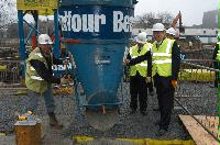 Photographs of Professor Timothy O'Shea and Mr Nichol Stephen MSP visiting the construction site for the Dugald Stewart Building and pouring some cement into the foundations.