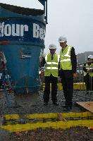 Photographs of Professor Timothy O'Shea and Mr Nichol Stephen MSP visiting the construction site for the Dugald Stewart Building and pouring some cement into the foundations.