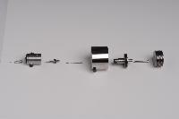 Photographs of a pressure cell, both in its fully assembled state and dismantled as a collection of individual parts. Unknown purpose, but possibly constructed by a team called "Hugh and Ronnie".