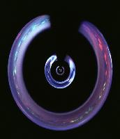 Images of rings in a tunnel arrangement, possibly with magnetic properties.