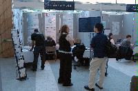 Photographs of stands at the UK e-Science All Hands Meeting, September 2008, in Appleton Tower, George Square. In the photographs four known people are present: Mr Gilbert Mensah, Dr Phil Trinder, Dr Mario Antonioletti and Dr Tim Parkinson. The rest are unknown.