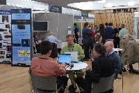 Photographs of stands at the UK e-Science All Hands Meeting, September 2008, in Appleton Tower, George Square. In the photographs four known people are present: Mr Gilbert Mensah, Dr Phil Trinder, Dr Mario Antonioletti and Dr Tim Parkinson. The rest are unknown.
