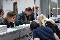 Photographs of people registering at the reception for the UK e-Science All Hands Meeting, September 2008, in the foyer of the Dugald Stewart Building at the University of Edinburgh, on Charles Street.