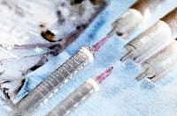 Photographs of a set of syringes.