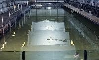 A photograph of some experiments with a device which generates electrical energy from wave kinetic energy.  8 images.