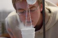 Photographs of Robert Dewar performing a superconductivity experiment, involving levitating magnets, during his 3rd Year Physics laboratories, January 2008.