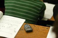 A set of photographs of Professor Simon Bates giving a lecture to a first year physics 1A class in 2005, possibly the first time PRS clickers were used.  Lecture hall was in Appleton tower.