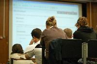 A set of photographs of Professor Simon Bates giving a lecture to a first year physics 1A class in 2005, possibly the first time PRS clickers were used.  Lecture hall was in Appleton tower.