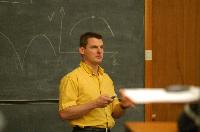 A set of photographs of Professor Simon Bates giving a lecture to a first year physics 1A class in 2005, possibly the first time PRS clickers were used.  Lecture hall was in Appleton tower.
