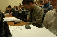 A set of photographs of Professor Simon Bates giving a lecture to a first year physics 1A class in 2005, possibly the first time PRS clickers were used.  Lecture hall was in Appleton tower.