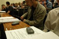 A set of photographs of Professor Simon Bates giving a lecture to a first year physics 1A class in 2005, possibly the first time PRS clickers were used.  Lecture hall was in Appleton tower.