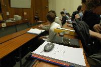 A set of photographs of Professor Simon Bates giving a lecture to a first year physics 1A class in 2005, possibly the first time PRS clickers were used.  Lecture hall was in Appleton tower.
