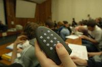 A set of photographs of Professor Simon Bates giving a lecture to a first year physics 1A class in 2005, possibly the first time PRS clickers were used.  Lecture hall was in Appleton tower.