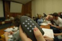 A set of photographs of Professor Simon Bates giving a lecture to a first year physics 1A class in 2005, possibly the first time PRS clickers were used.  Lecture hall was in Appleton tower.