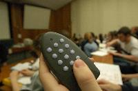 A set of photographs of Professor Simon Bates giving a lecture to a first year physics 1A class in 2005, possibly the first time PRS clickers were used.  Lecture hall was in Appleton tower.