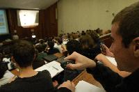 A set of photographs of Professor Simon Bates giving a lecture to a first year physics 1A class in 2005, possibly the first time PRS clickers were used.  Lecture hall was in Appleton tower.