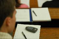 A set of photographs of Professor Simon Bates giving a lecture to a first year physics 1A class in 2005, possibly the first time PRS clickers were used.  Lecture hall was in Appleton tower.