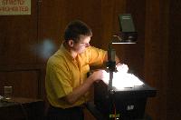 A set of photographs of Professor Simon Bates giving a lecture to a first year physics 1A class in 2005, possibly the first time PRS clickers were used.  Lecture hall was in Appleton tower.