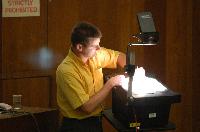A set of photographs of Professor Simon Bates giving a lecture to a first year physics 1A class in 2005, possibly the first time PRS clickers were used.  Lecture hall was in Appleton tower.