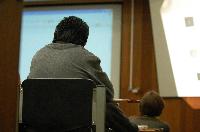 A set of photographs of Professor Simon Bates giving a lecture to a first year physics 1A class in 2005, possibly the first time PRS clickers were used.  Lecture hall was in Appleton tower.