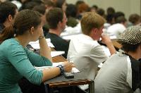 A set of photographs of Professor Simon Bates giving a lecture to a first year physics 1A class in 2005, possibly the first time PRS clickers were used.  Lecture hall was in Appleton tower.