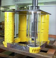 Two men set up an experiment in a water tank for what is likely a fluid dynamics experiment.  A laser is used in the water - possibly for particle image velocimetry / PIV.  What looks like an oil platform is set up above the water for some unknown testing.  10 images.